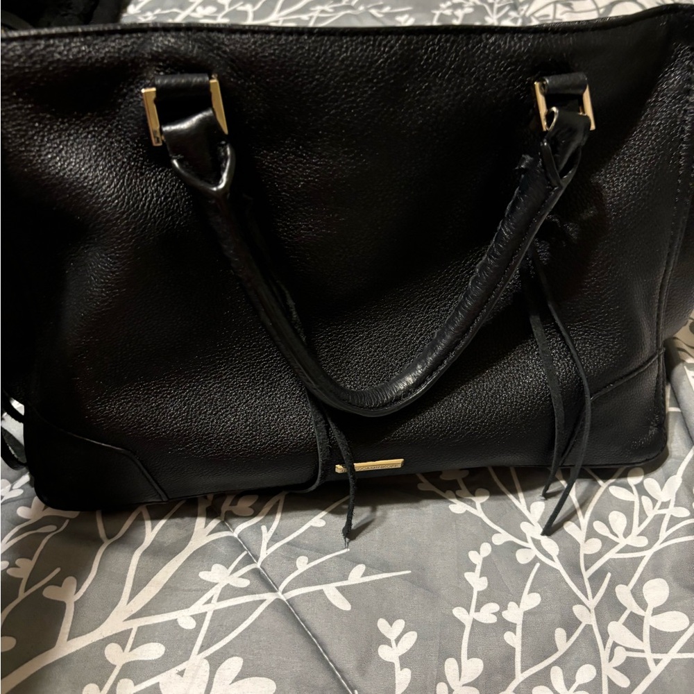 Rebecca Minkoff black leather handbag with fringe details.
